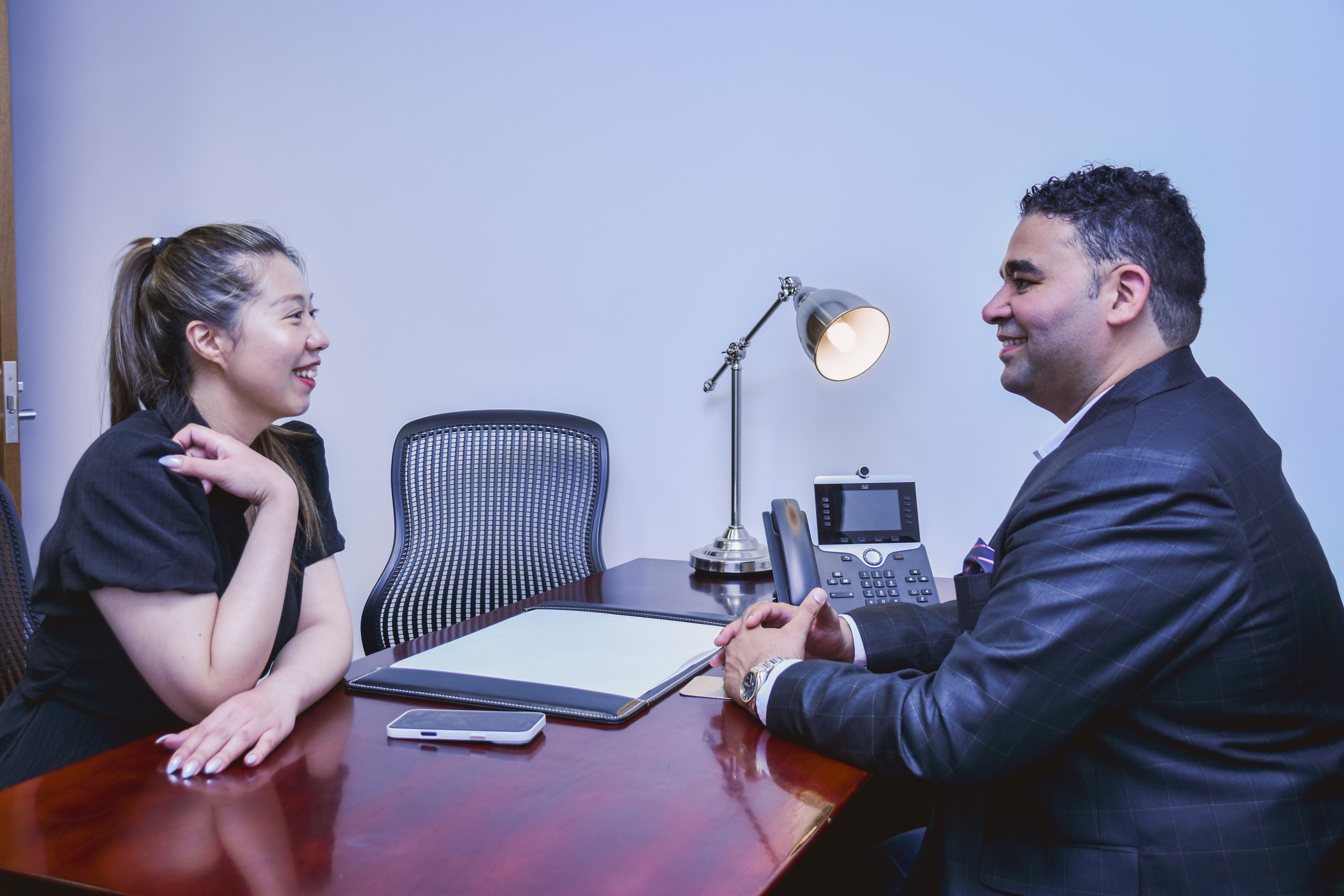 Colleagues in discussion at a desk